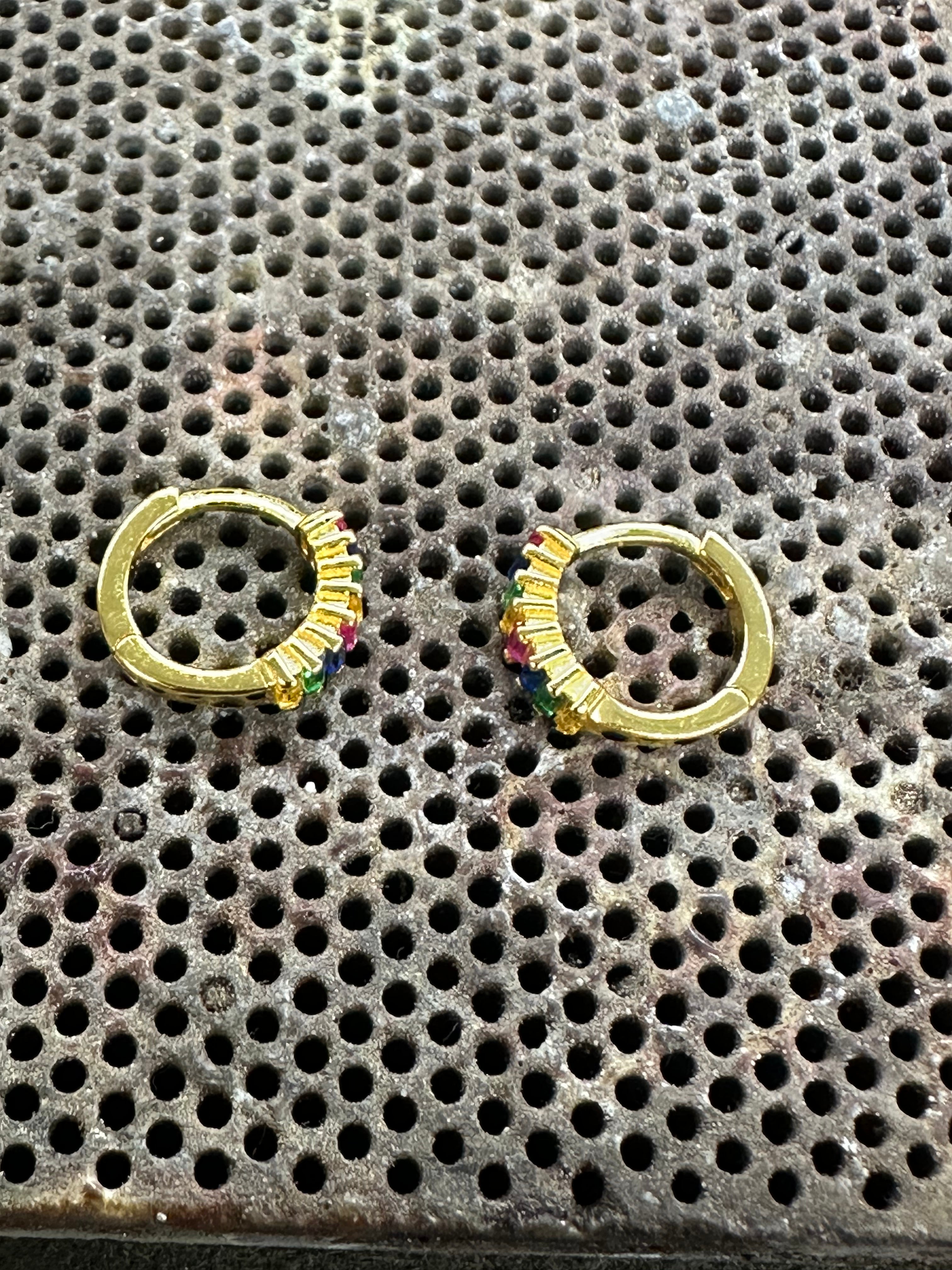 Exquisite 14K Gold Rainbow Baguette Huggie Hoop Earrings – Colorful Small Hoops
Description:
Brighten up your look with these 14K gold-plated sterling silver rainbow baguette huggie hoop earrings, featuring eight vibrant multi-color baguette-cut cubic z
